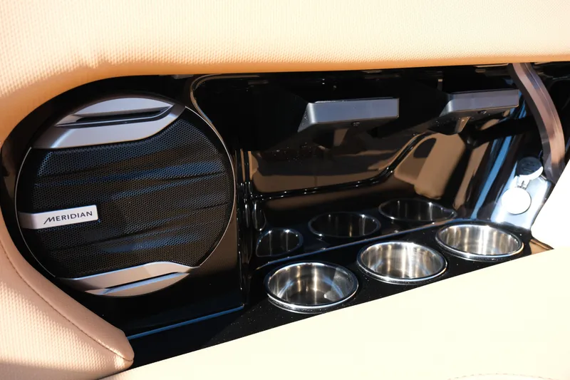 Slide: The Image of Interior of 2026 MasterCraft NXT24 featuring Meridian speaker and stainless steel cup holders. - 22