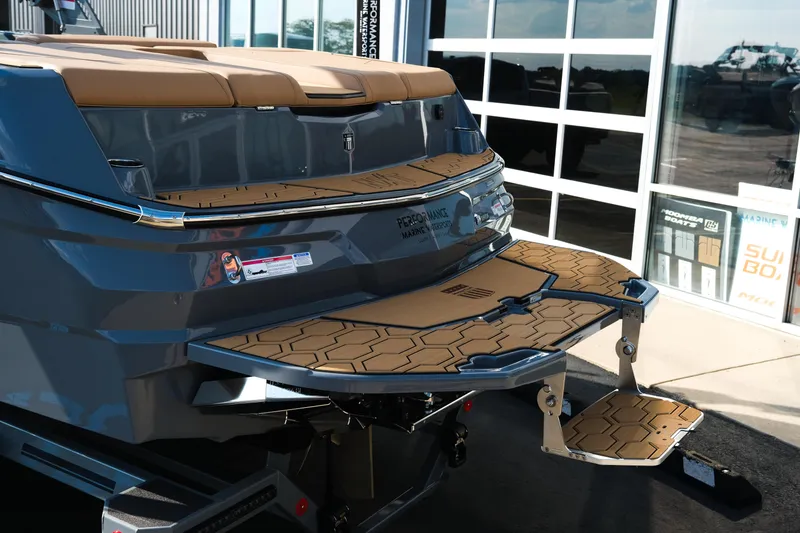 Slide: The Image of 2026 MasterCraft NXT24 boat with sleek design and modern features at a showroom. - 5