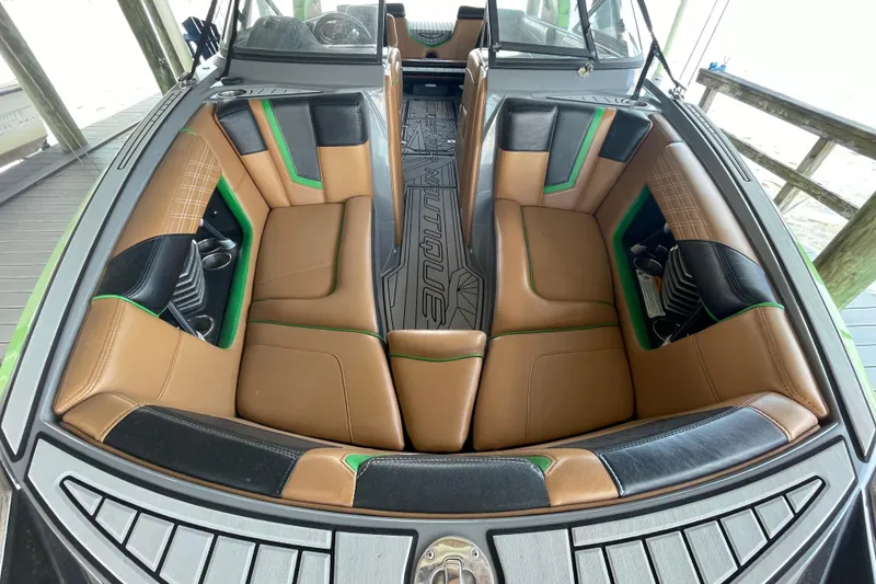 Slide: The Image of 2016 Nautique Super Air Nautique G23 Coastal Edition interior with tan and black seating. - 10