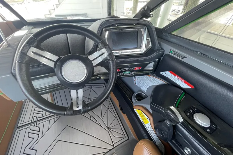 Slide: The Image of 2016 Nautique Super Air Nautique G23 Coastal Edition dashboard with steering wheel and controls. - 5