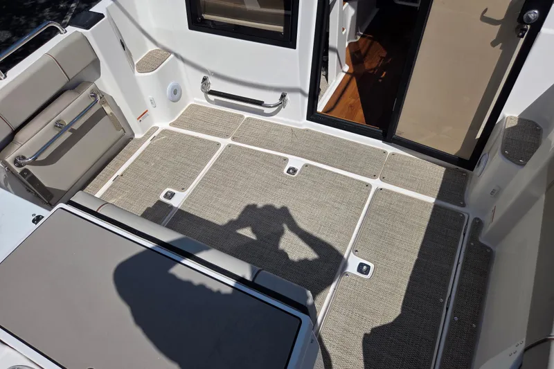 Slide: The Image of 2026 Cutwater C-248 Coupe cockpit with cushioned seating and carpeted flooring. - 8