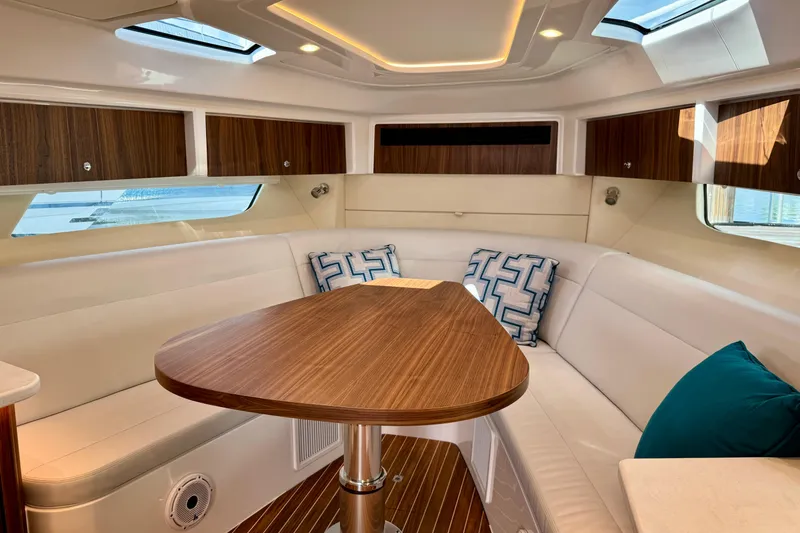 Slide: The Image of Luxurious interior of 2026 Intrepid 50 Evolution yacht with elegant seating and wooden table. - 12