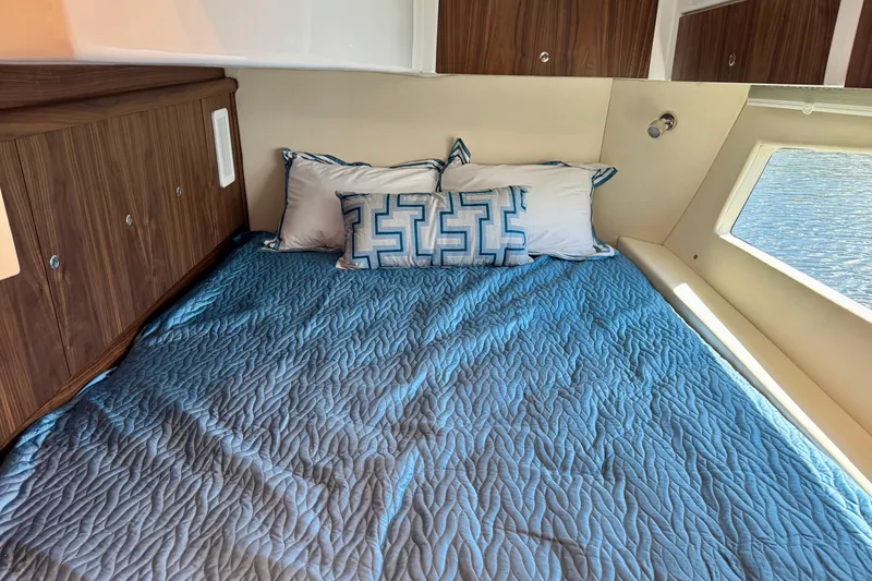 Slide: The Image of Luxurious cabin interior of 2026 Intrepid 50 Evolution yacht with blue bedding. - 16