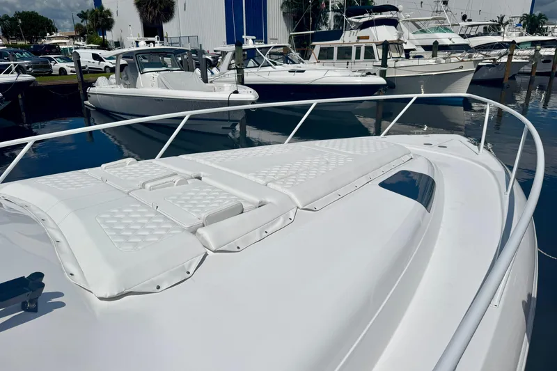 Slide: The Image of 2026 Intrepid 50 Evolution yacht docked, showcasing sleek design and spacious deck. - 17