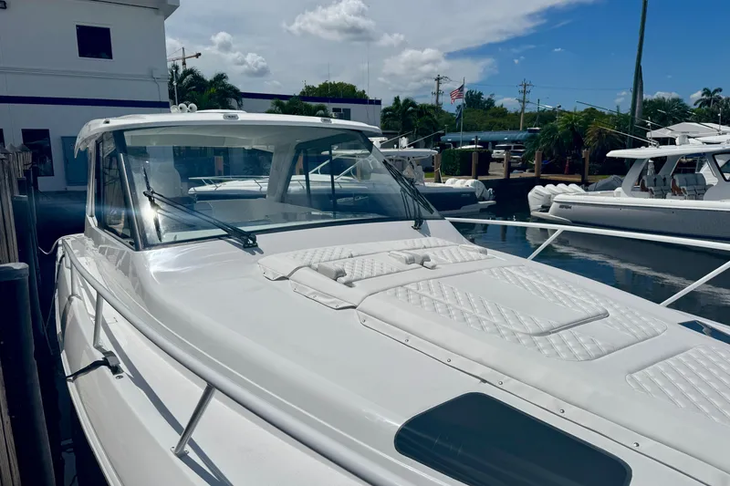 Slide: The Image of 2026 Intrepid 50 Evolution yacht docked at marina under clear sky. - 18