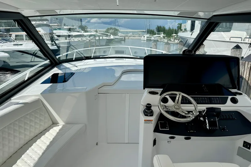 Slide: The Image of Interior view of 2026 Intrepid 50 Evolution yacht cockpit with modern steering and controls. - 2