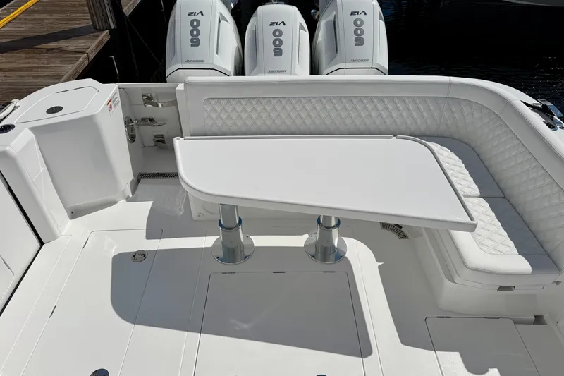 Slide: The Image of 2026 Intrepid 50 Evolution boat interior with white seating and table. - 22