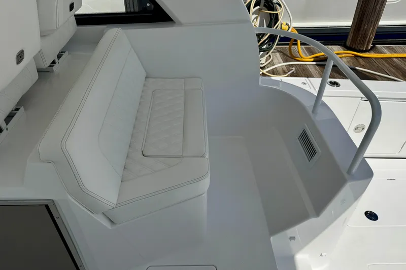 Slide: The Image of Luxurious seating area on 2026 Intrepid 50 Evolution yacht, featuring white upholstery and sleek design. - 23