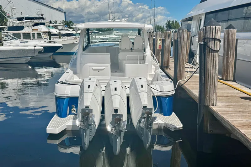 Slide: The Image of 2026 Intrepid 50 Evolution boat docked with triple outboard engines. - 25