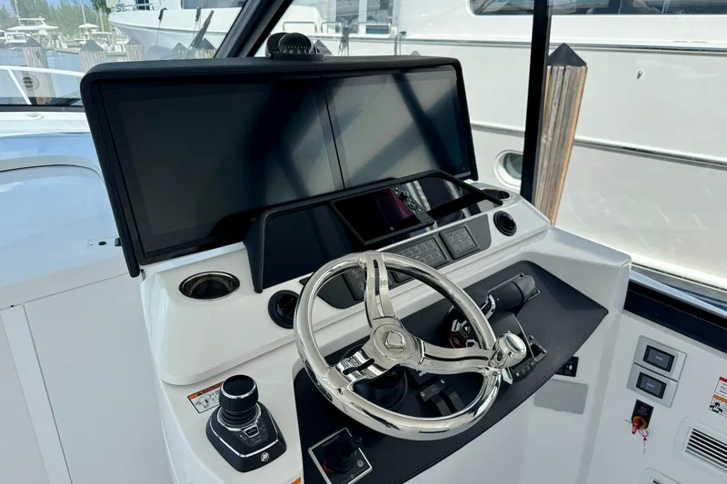 Slide: The Image of Helm of 2026 Intrepid 50 Evolution yacht with modern controls and navigation screens. - 3