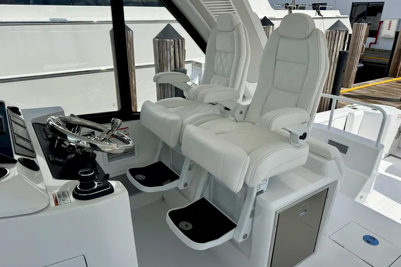 Slide: The Image of Luxury helm seating on 2026 Intrepid 50 Evolution yacht, featuring sleek design and modern controls. - 4