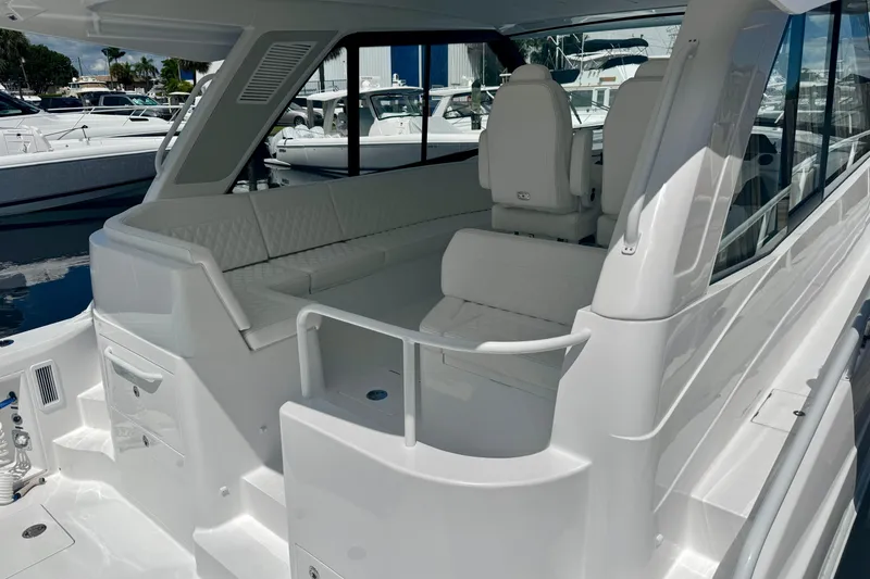 Slide: The Image of 2026 Intrepid 50 Evolution yacht interior with white seating and modern design. - 5