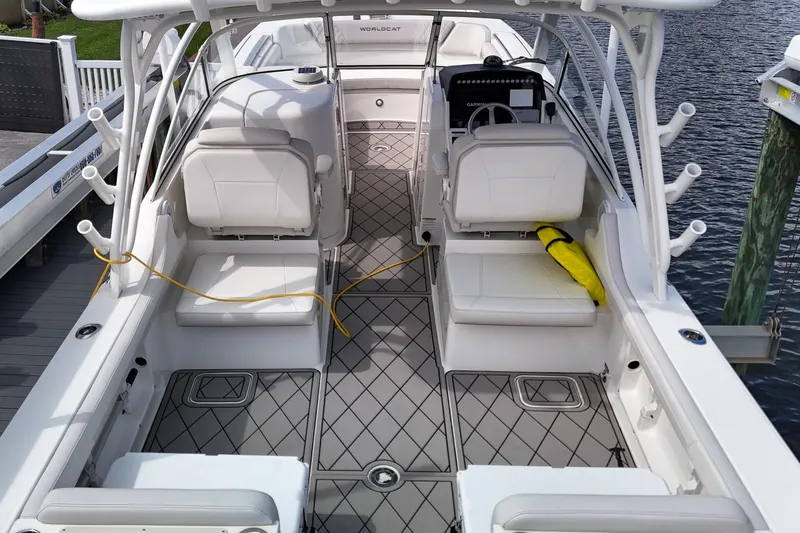 Slide: The Image of 2024 World Cat 296DC boat interior with seating, docked by the water. - 11