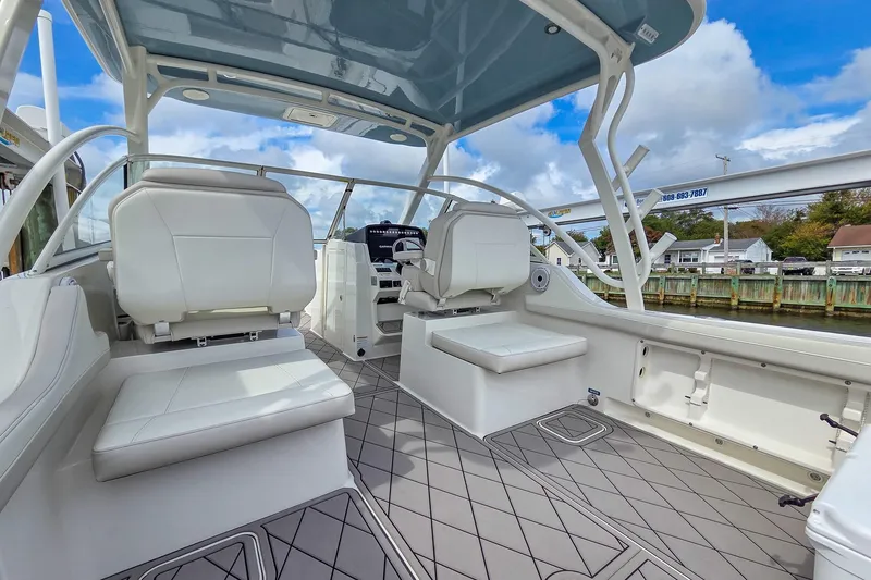 Slide: The Image of 2024 World Cat 296DC boat interior with white seating and modern design. - 12