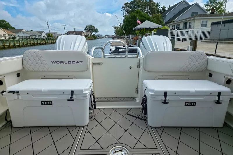 Slide: The Image of 2024 World Cat 296DC boat interior with Yeti coolers and diamond-patterned seating. - 14