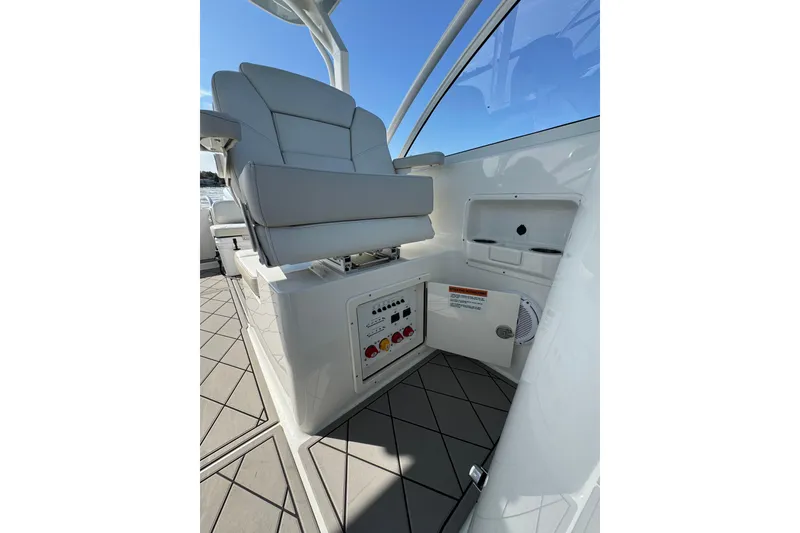 Slide: The Image of 2024 World Cat 296 DC boat interior with white seating and control panel. - 26