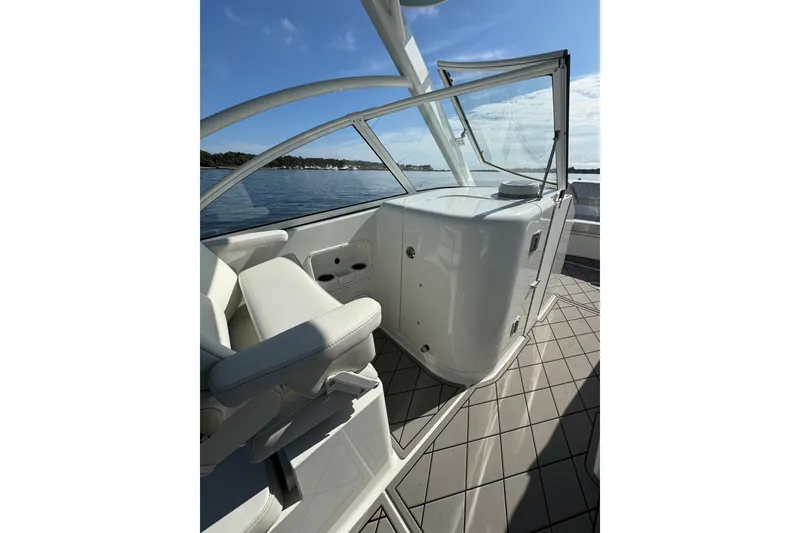 Slide: The Image of 2024 World Cat 296 DC boat interior with seating and open water view. - 29