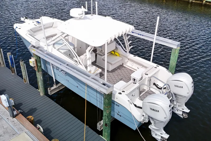 Slide: The Image of 2024 World Cat 296DC boat docked, featuring sleek design and spacious seating. - 3