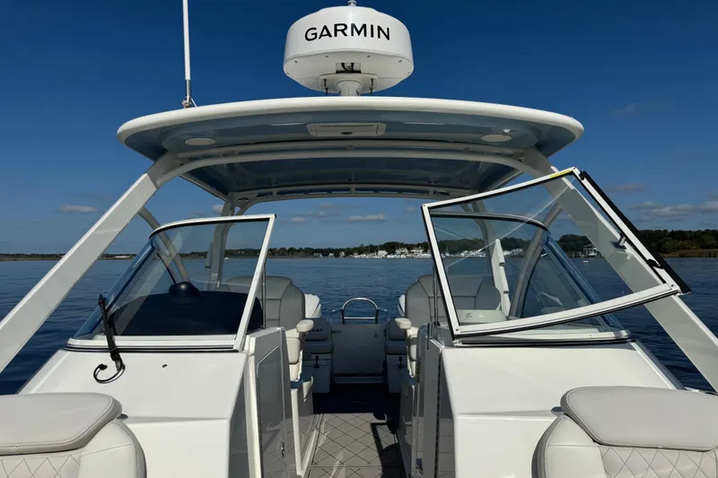 Slide: The Image of 2024 World Cat 296 DC boat with Garmin equipment on calm water. - 32