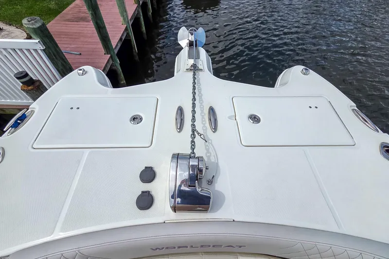 Slide: The Image of 2024 World Cat 296DC boat deck with anchor chain, docked by water. - 36