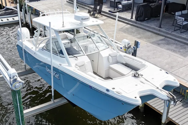 Slide: The Image of 2024 World Cat 296DC boat docked, featuring spacious seating and modern design. - 4