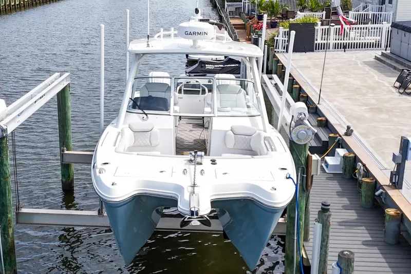 Slide: The Image of 2024 World Cat 296DC boat docked, featuring dual Yamaha engines and spacious seating. - 5