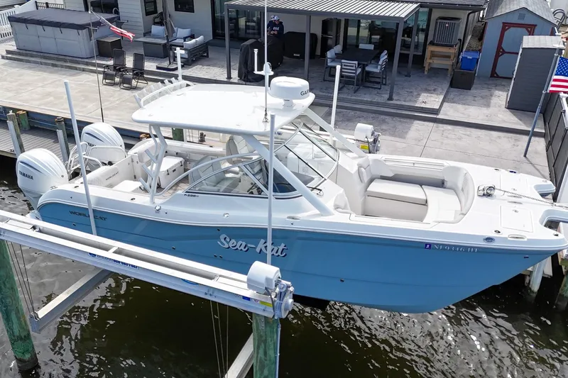 Slide: The Image of 2024 World Cat 296DC boat docked, featuring dual Yamaha 300 V6 engines. - 6