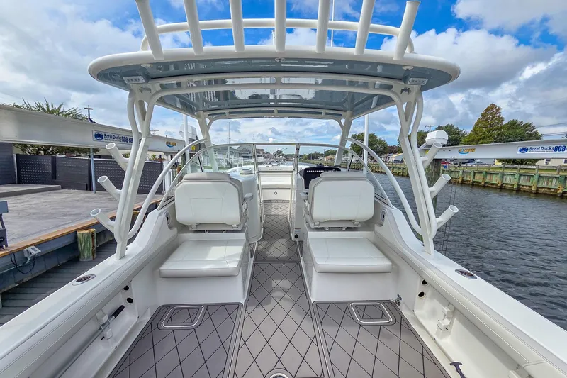 Slide: The Image of 2024 World Cat 296 DC boat with dual Yamaha engines on water. - 9