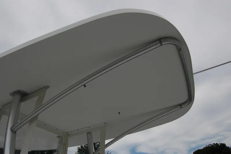 Slide: The Image of Close-up of Composite Yacht 26 hardtop, 2013 model, against cloudy sky. - 18