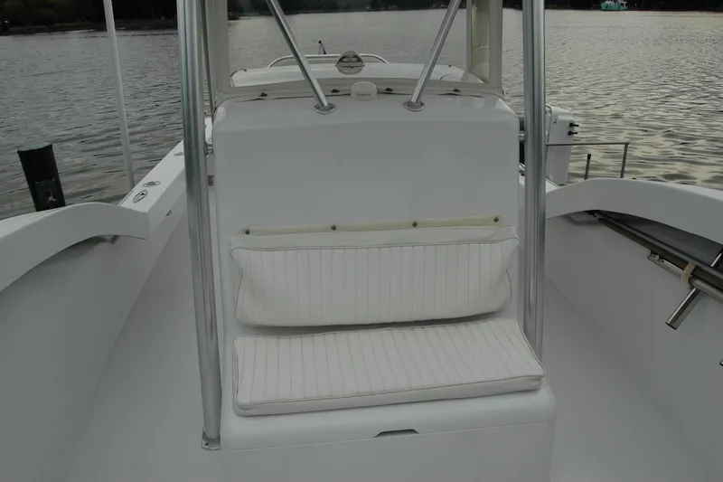 Slide: The Image of White seating area on a 2013 Composite Yacht 26, with water in the background. - 26