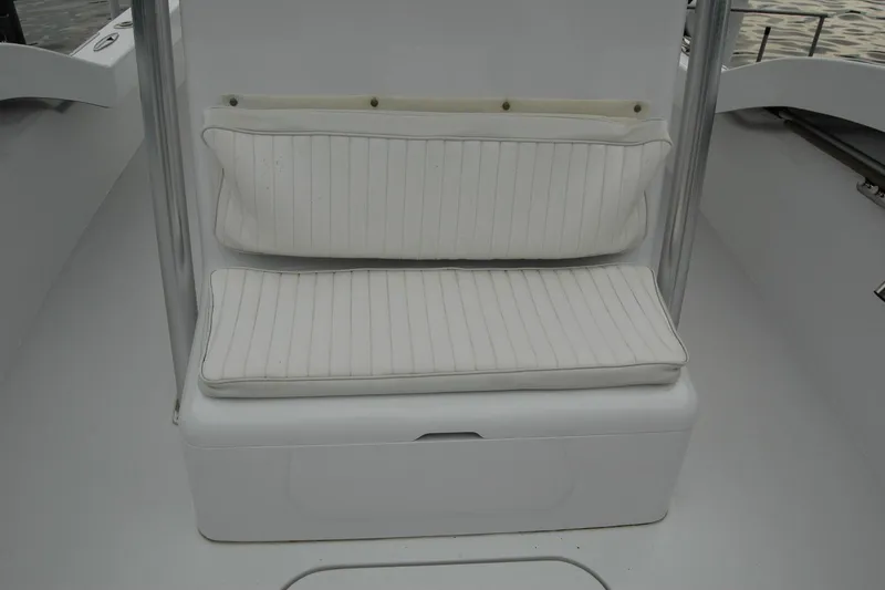 Slide: The Image of White cushioned seating on 2013 Composite Yacht 26, featuring sleek design and comfort. - 30