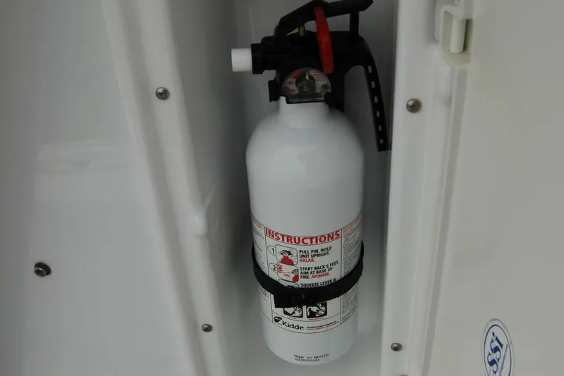 Slide: The Image of Fire extinguisher mounted on 2013 Composite Yacht 26 interior wall. - 33