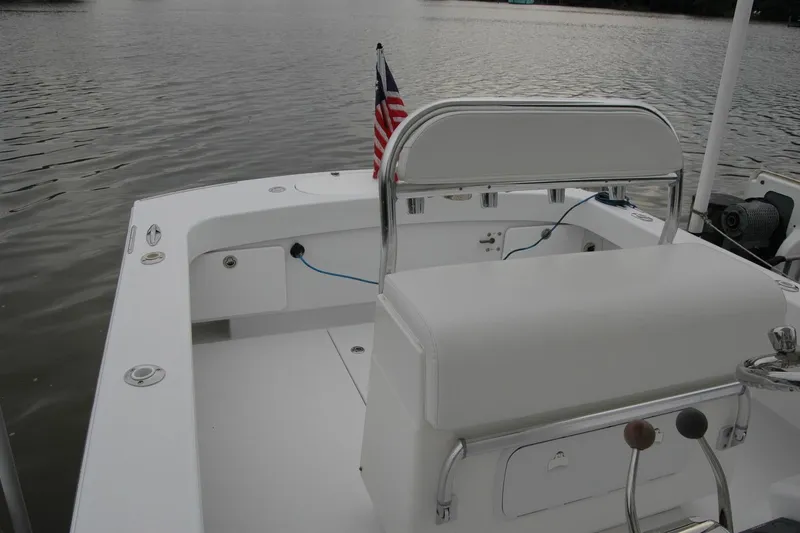 Slide: The Image of 2013 Composite Yacht 26 on calm water, featuring a sleek white deck and American flag. - 34