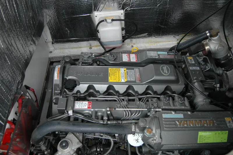 Slide: The Image of Engine compartment of a 2013 Composite Yacht 26, featuring a Yanmar 24-valve engine. - 35