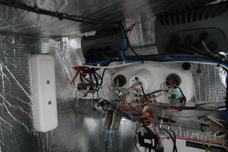 Slide: The Image of Electrical wiring and components inside a 2013 Composite Yacht 26, with reflective insulation. - 39