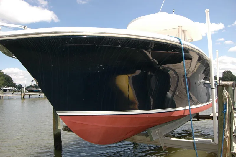 Slide: The Image of 2013 Composite Yacht 26 on lift, showcasing sleek black hull and red bottom paint. - 4