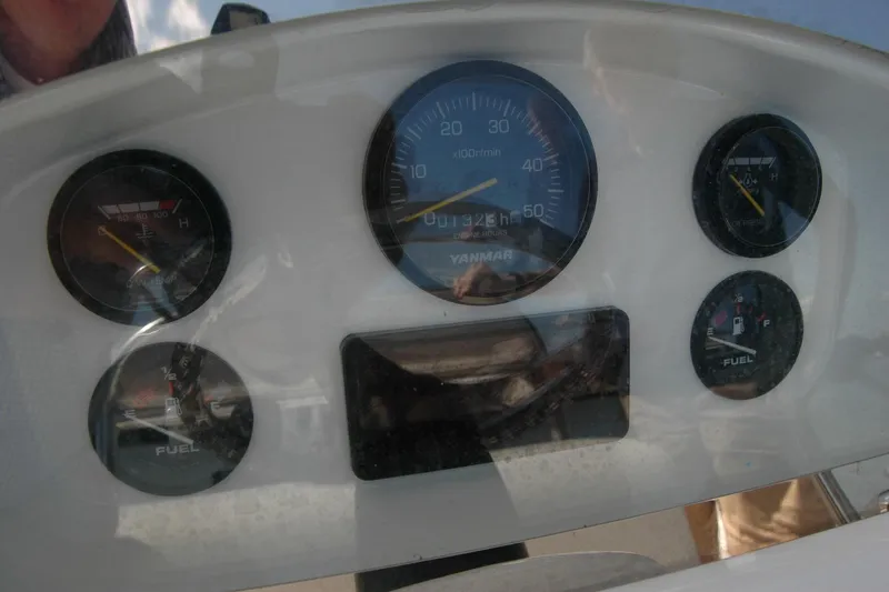 Slide: The Image of Dashboard of 2013 Composite Yacht 26 with fuel and temperature gauges. - 46