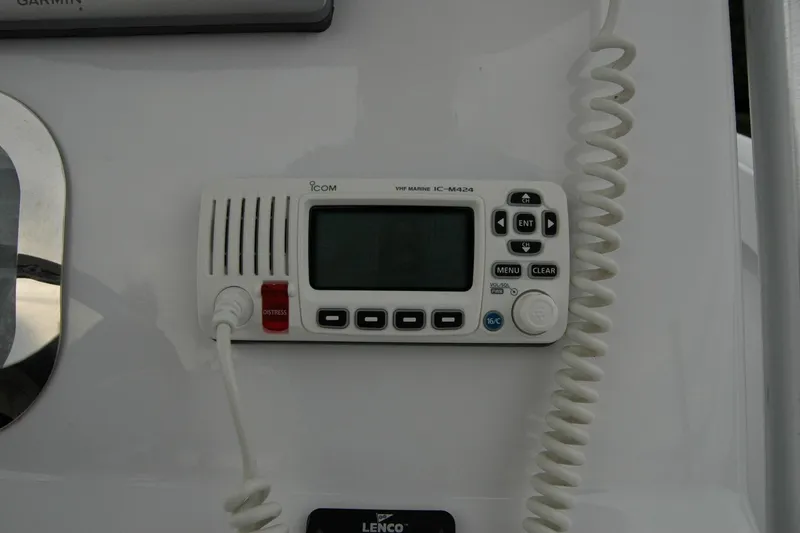 Slide: The Image of VHF marine radio on 2013 Composite Yacht 26 dashboard, featuring Icom IC-M424 model. - 48