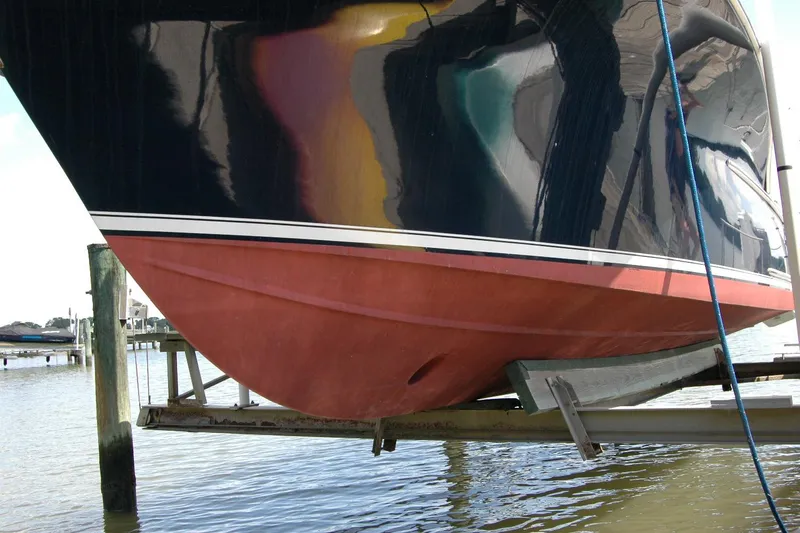 Slide: The Image of 2013 Composite Yacht 26 on lift, showcasing hull design and vibrant colors. - 5