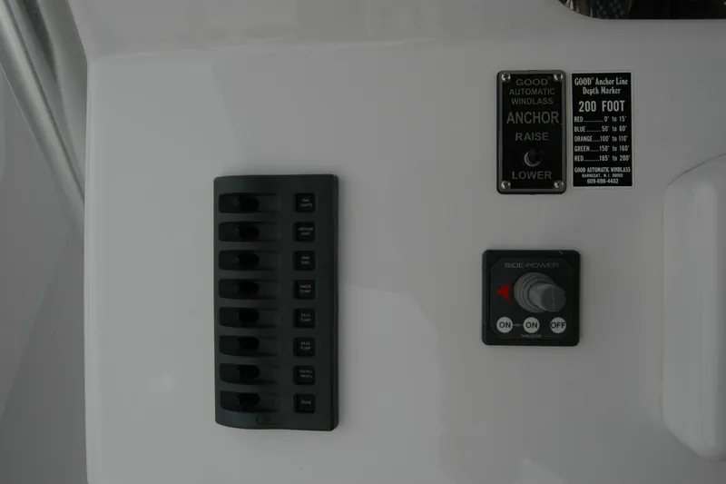 Slide: The Image of Control panel on a 2013 Composite Yacht 26, featuring switches and anchor controls. - 51