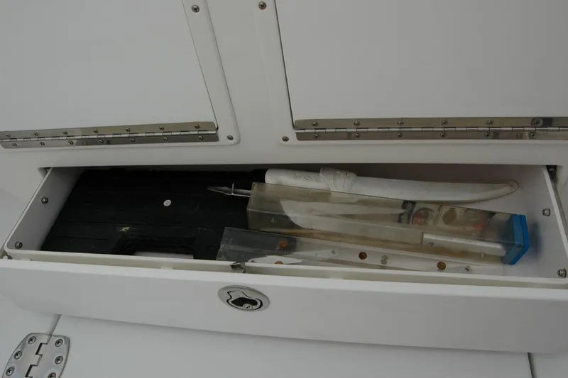 Slide: The Image of Storage compartment on 2013 Composite Yacht 26 with fishing gear and tools. - 57