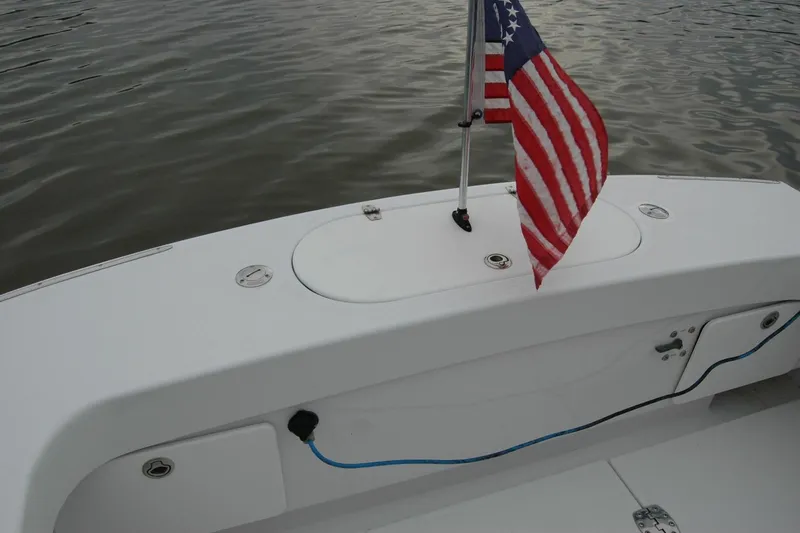 Slide: The Image of 2013 Composite Yacht 26 with American flag on calm water. - 59
