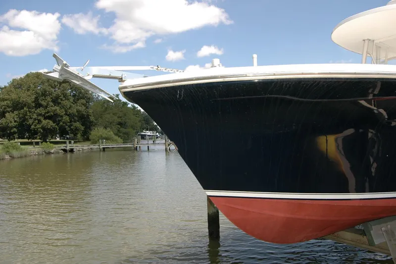 Slide: The Image of 2013 Composite Yacht 26 docked on a calm river under a clear blue sky. - 6
