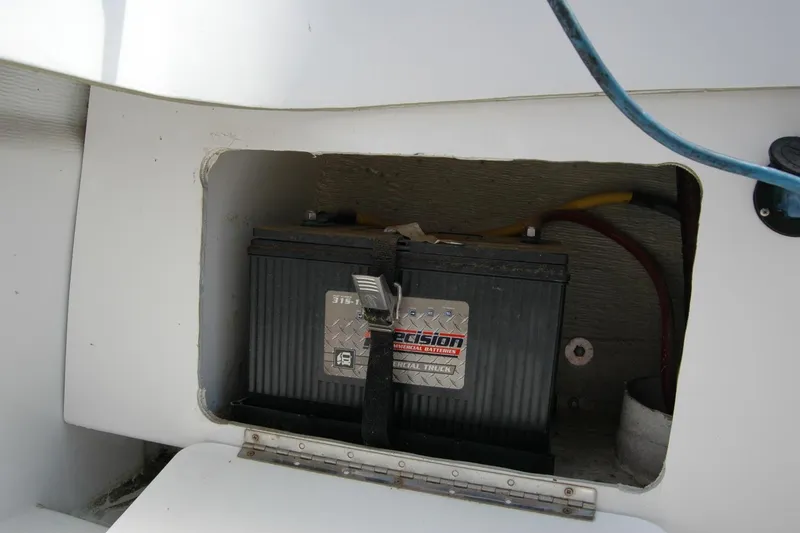 Slide: The Image of Battery compartment of 2013 Composite Yacht 26 with visible wiring. - 60