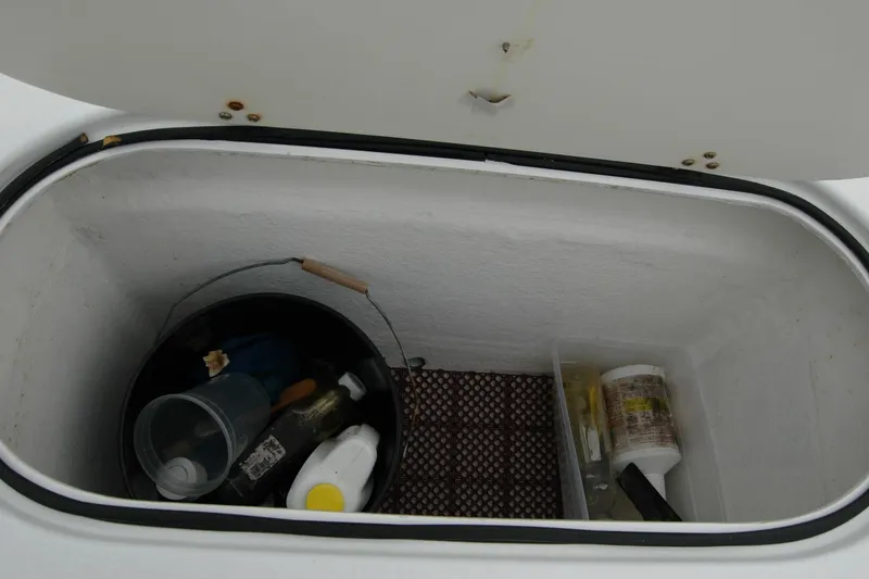 Slide: The Image of Storage compartment on 2013 Composite Yacht 26 with cleaning supplies and tools. - 63