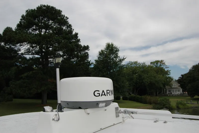 Slide: The Image of Radar equipment on 2013 Composite Yacht 26, surrounded by trees and a house in the background. - 67