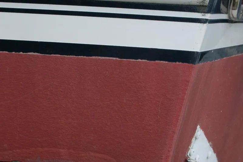 Slide: The Image of Close-up of 2013 Composite Yacht 26 hull with red and white paint. - 8