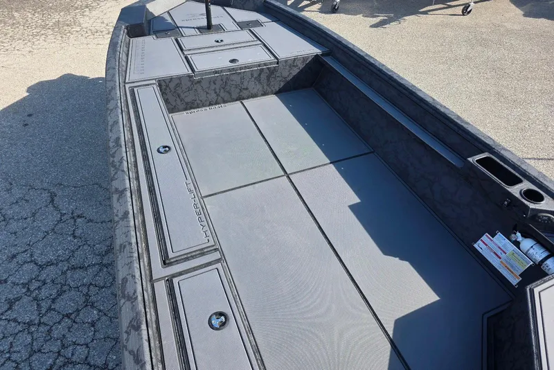 Slide: The Image of 2026 Xpress X18DB boat interior with Hyper-Lift hull design, featuring storage compartments and non-slip flooring. - 10