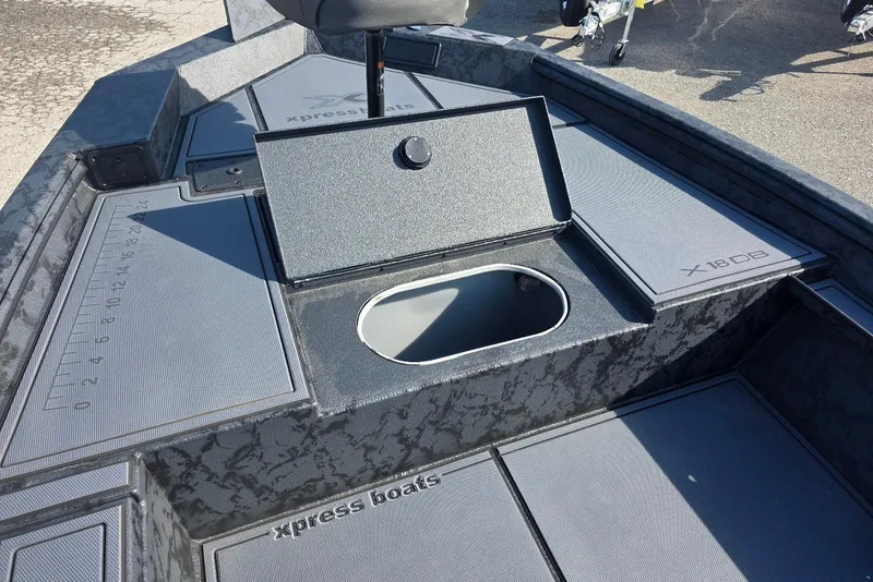 Slide: The Image of 2026 Xpress X18DB boat interior with storage compartment and measuring guide. - 12