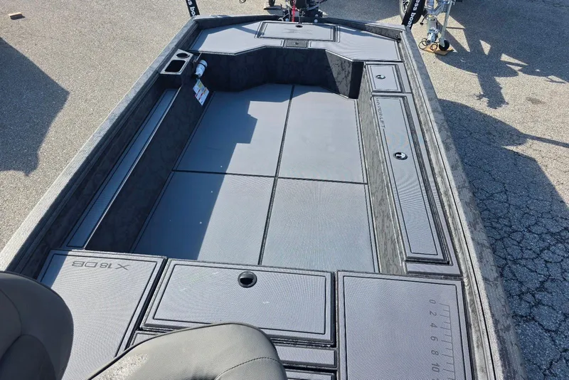 Slide: The Image of 2026 Xpress X18DB boat interior with spacious deck and storage compartments. - 14